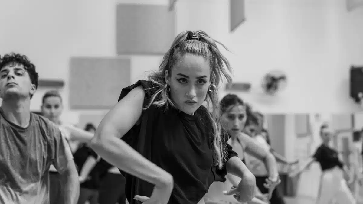 Energetic dancers in black and white capturing a rehearsal session.