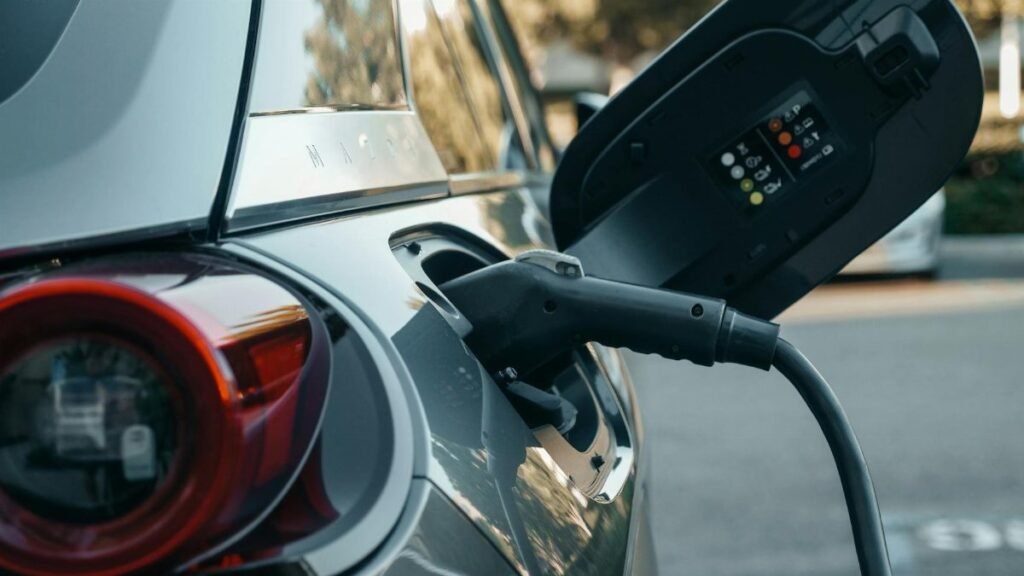 Close-up of an electric vehicle being charged, highlighting modern clean energy technology.
