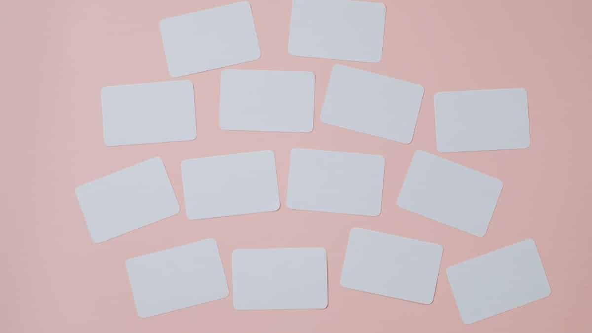 Abstract minimalist photo of blank cards on a pastel pink background, ideal for copyspace.