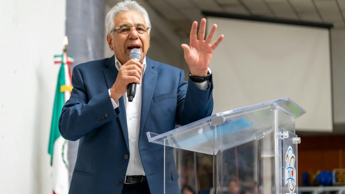 A politician delivers a passionate speech at an indoor public gathering in Mexico.