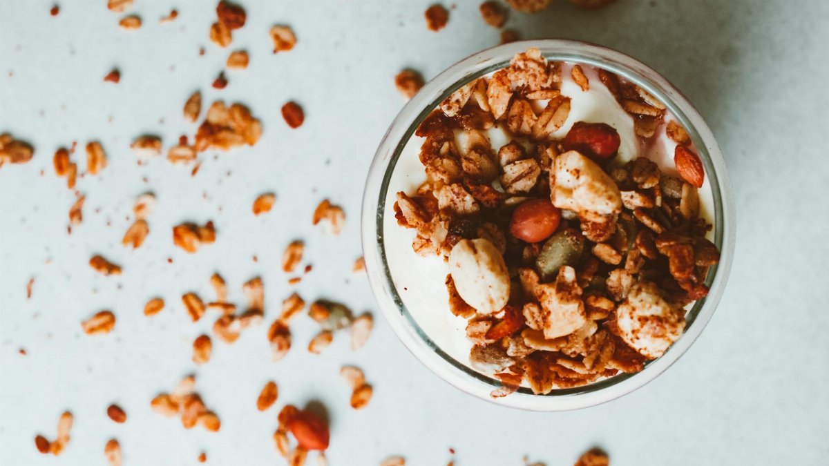 Delicious yogurt parfait topped with crunchy granola and nuts, perfect for a healthy breakfast.