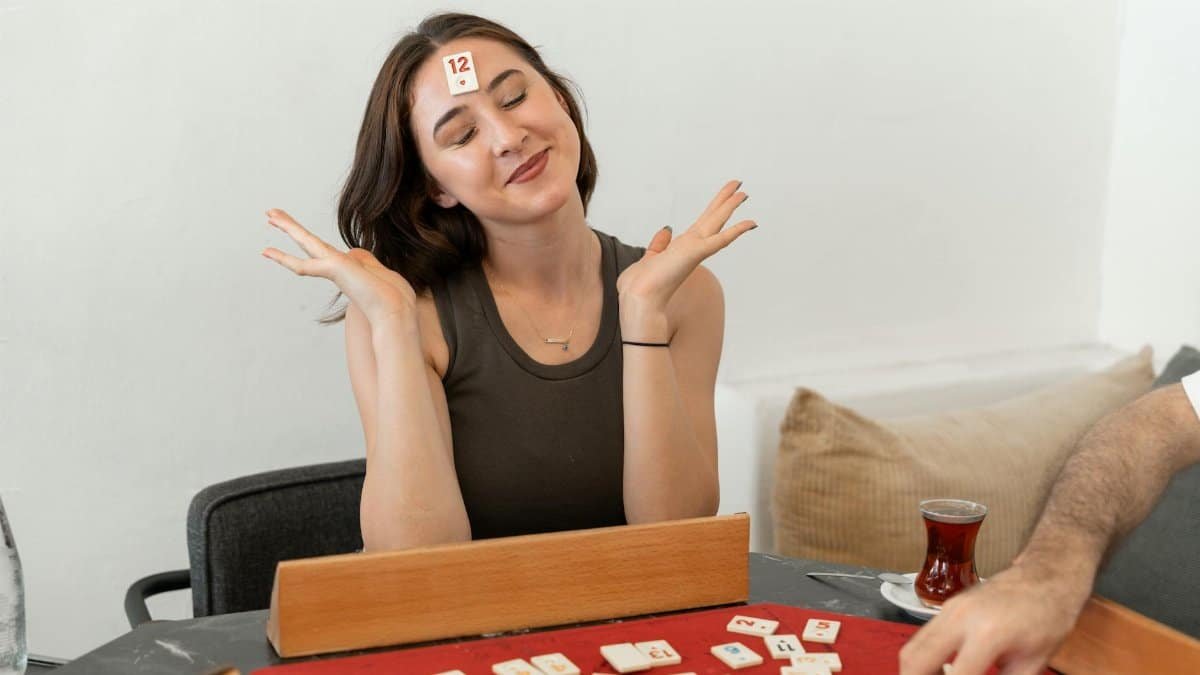 Woman enjoying a light-hearted board game indoors, expressing fun and relaxation in Yalova, Türkiye.