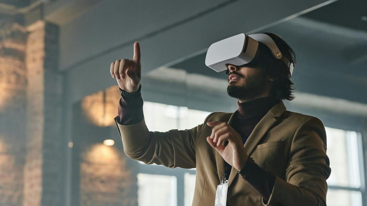 Businessman engaging with virtual reality technology indoors, pointing finger.