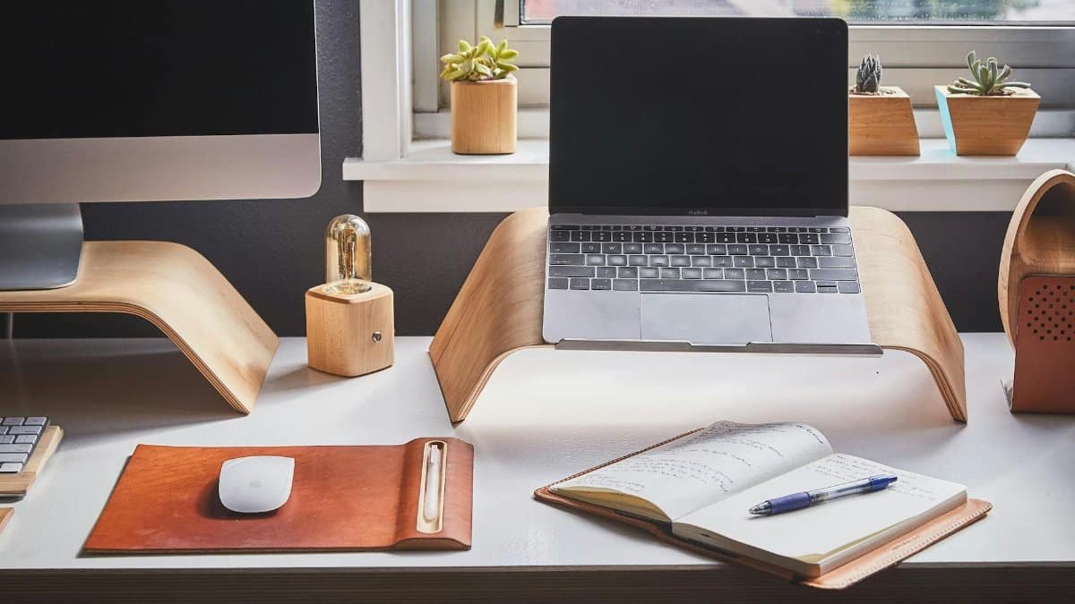 A stylish and contemporary home office setup with laptop and desk accessories.
