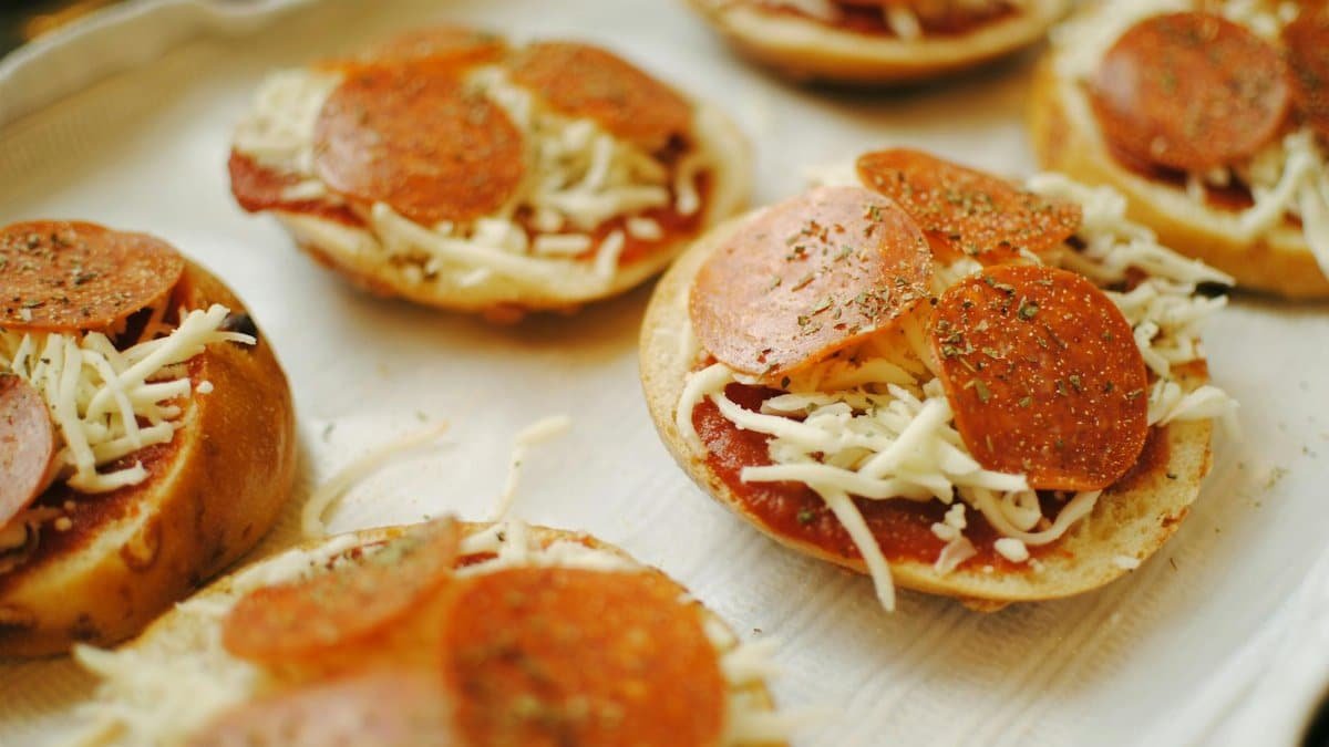 Close-up of fresh homemade pepperoni pizza bagels with cheese and herbs.