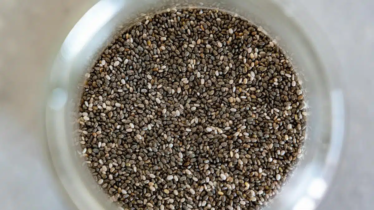 High-angle view of chia seeds in a glass jar, perfect for healthy cooking.