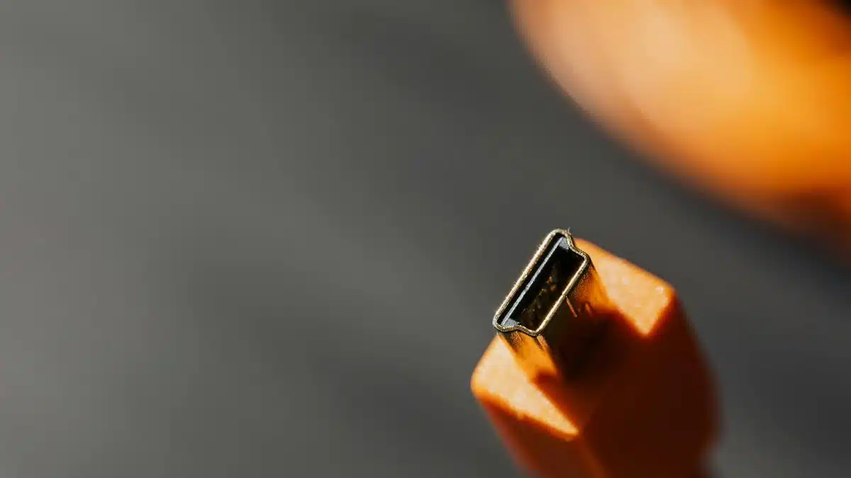Detailed macro shot of an orange USB connector with a blurred background.