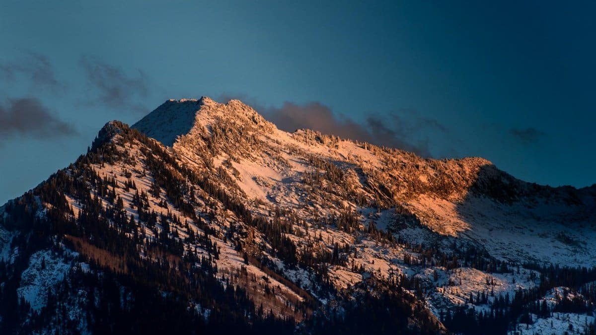 Experience the serene beauty of a snow-capped mountain peak at sunrise in Salt Lake City.