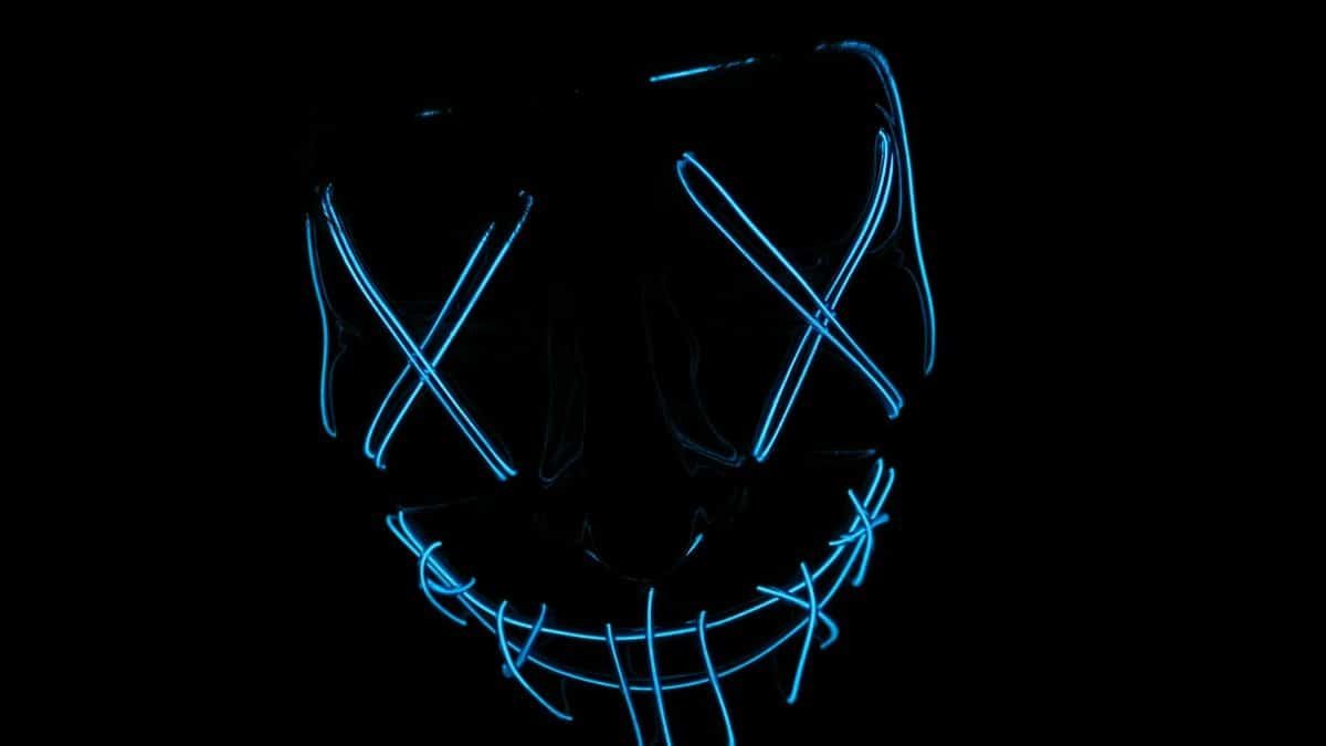 Futuristic neon blue LED mask glowing in the dark, ideal for tech and cyber themes.