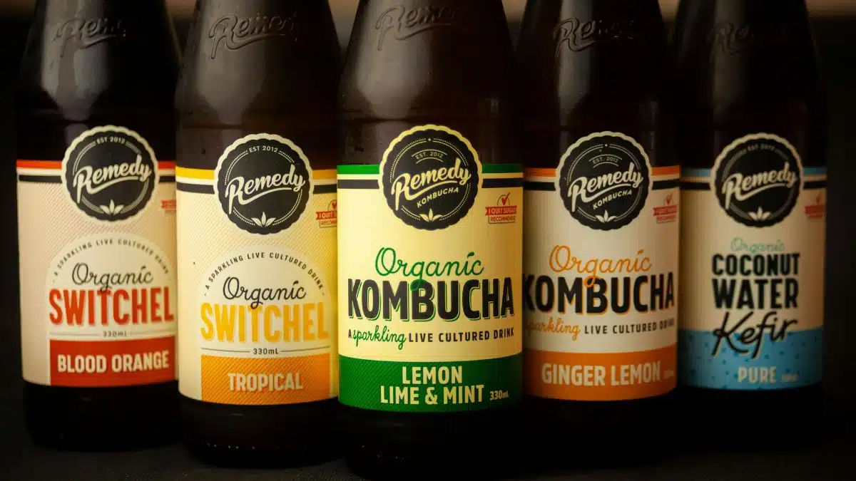 Close-up of five bottles featuring organic kombucha, switchel, and kefir with various flavors.