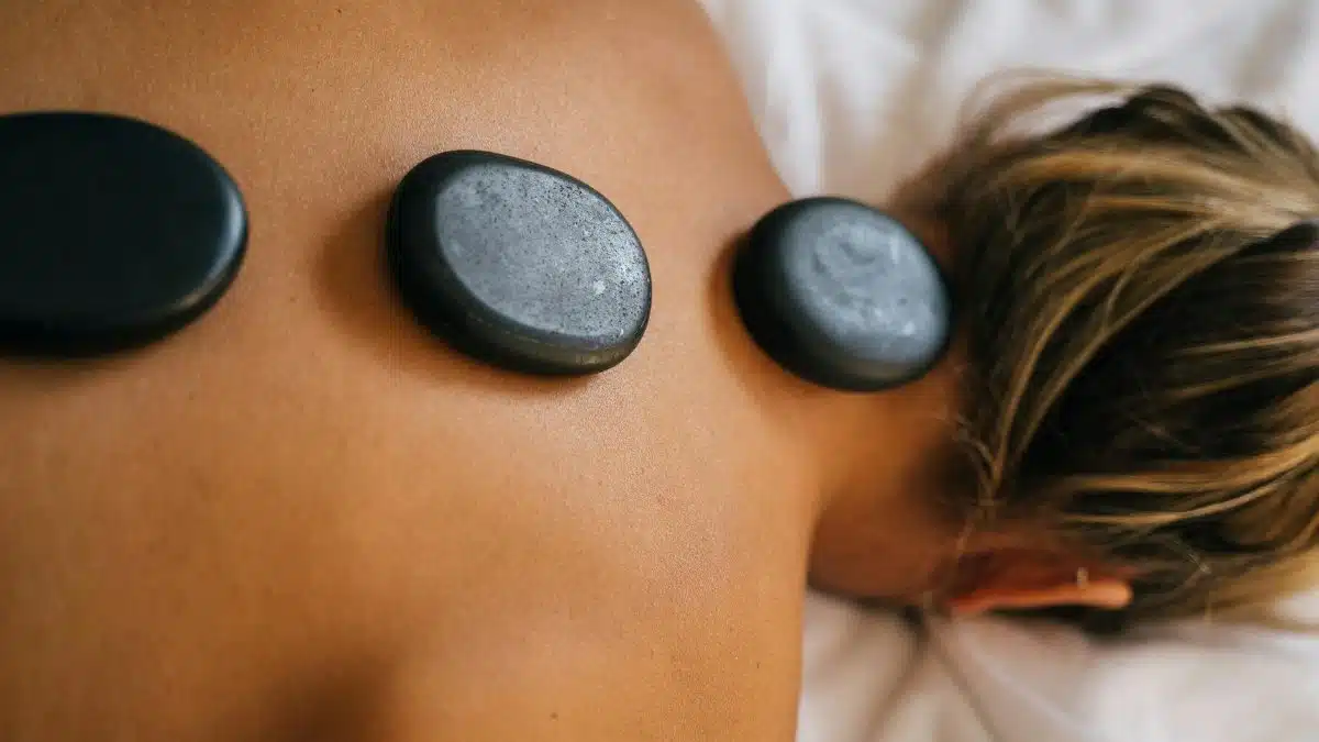Peaceful spa setting with hot stone therapy promoting relaxation and relief.