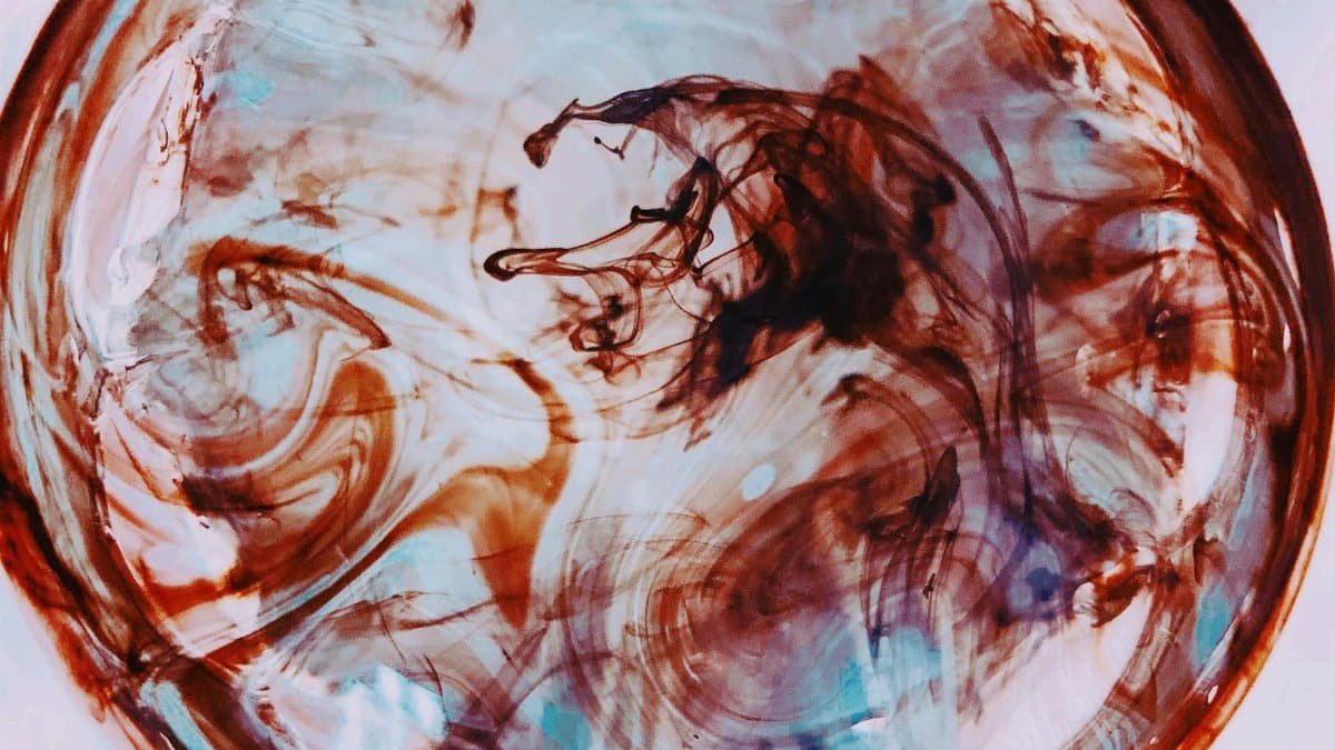 Vibrant abstract close-up of swirling paint in a circular pattern. Modern art style.