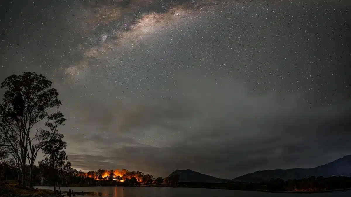 Beautiful night sky with Milky Way visible over Maroon Lake, Australia, featuring starry night and tranquil waters.