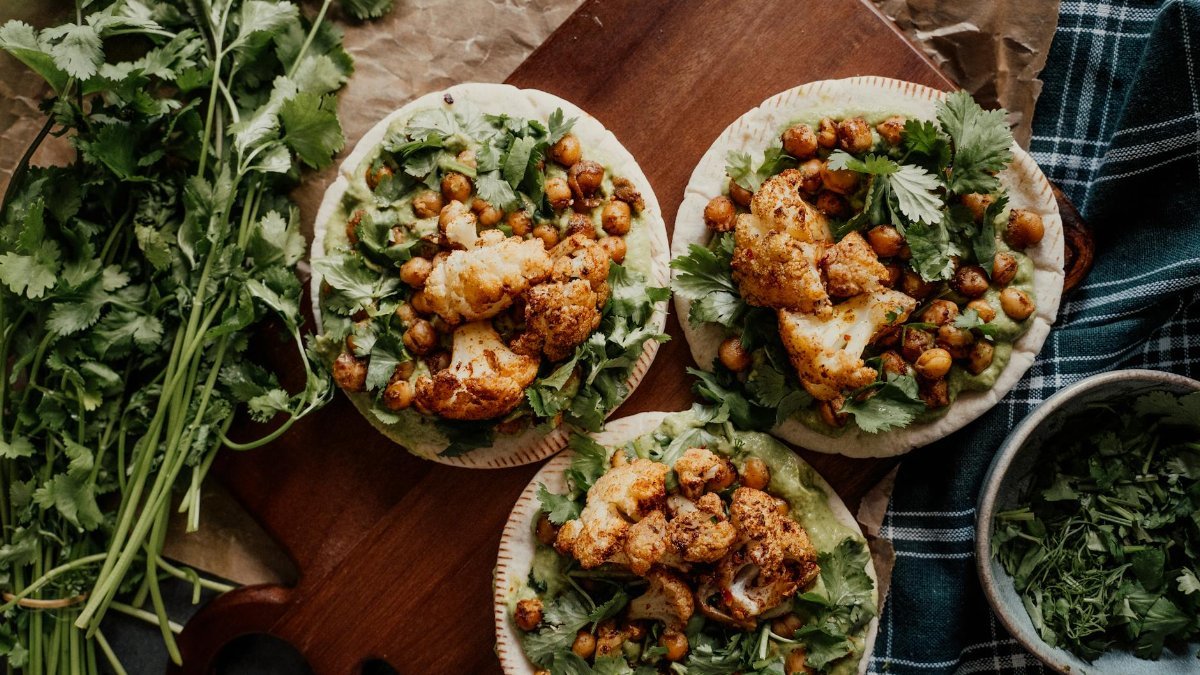 Delicious vegan tacos featuring roasted cauliflower and chickpeas with cilantro, perfect for a healthy meal.
