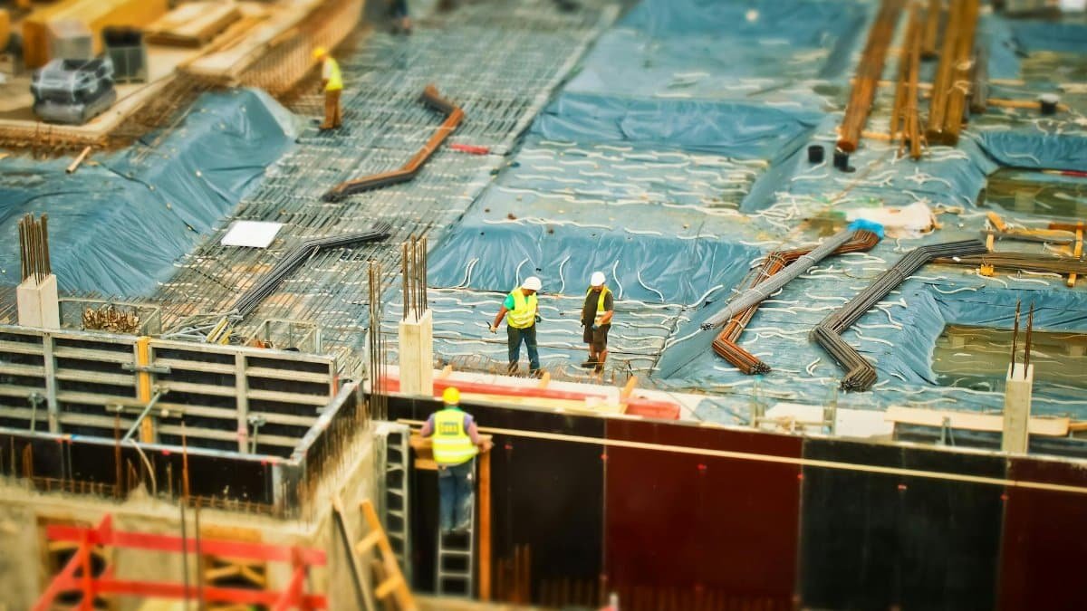 High-angle view of construction workers on a building site, engaging in construction work.