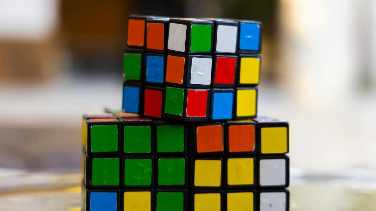 Close-up of two stacked Rubik's Cubes showcasing multi-colored squares for puzzle enthusiasts.