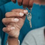 A couple holding a key, symbolizing a new home ownership or rental.