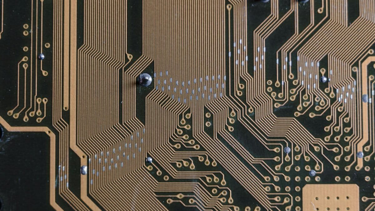 Detailed view of a circuit board with intricate gold traces.