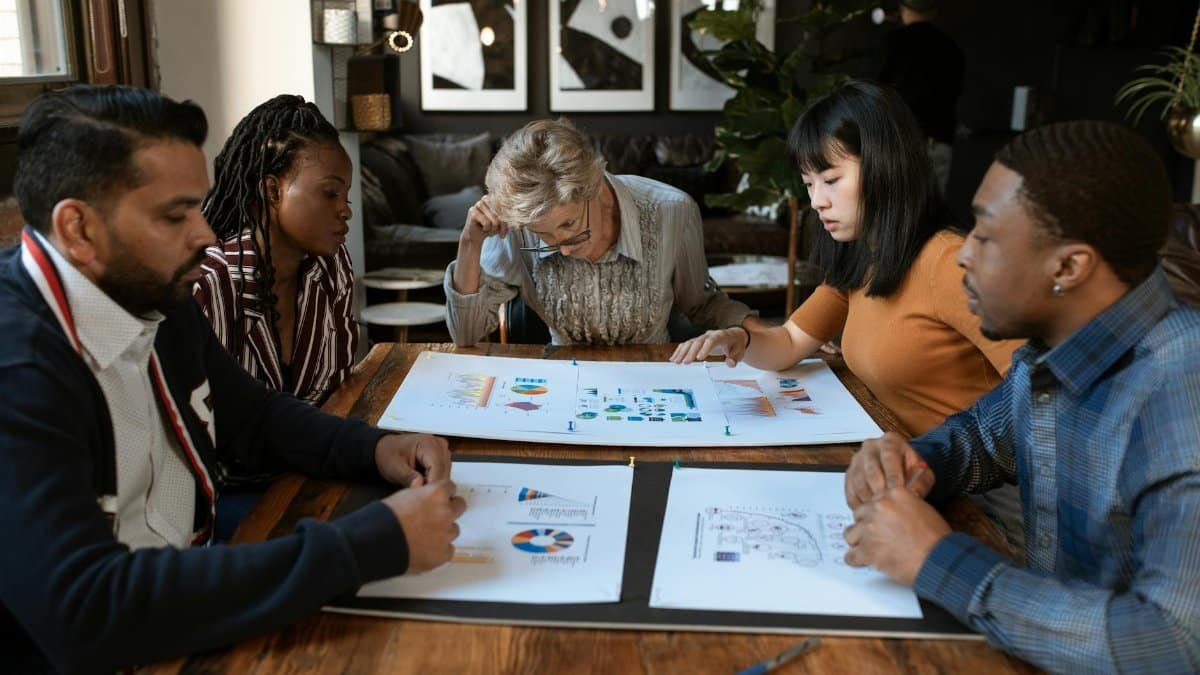 A diverse group of professionals engaged in a collaborative meeting in a modern office setting.