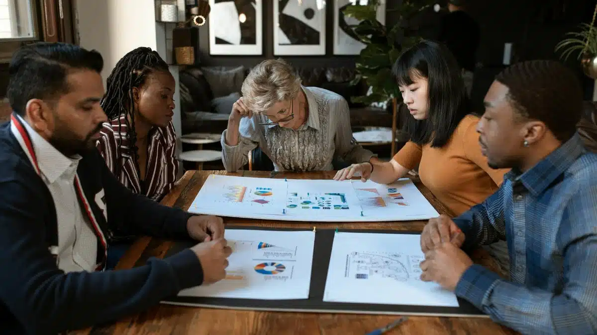 A diverse group of professionals engaged in a collaborative meeting in a modern office setting.