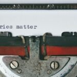 Close-up of a vintage typewriter with the text 'Stories matter' typed on paper, evoking nostalgia.