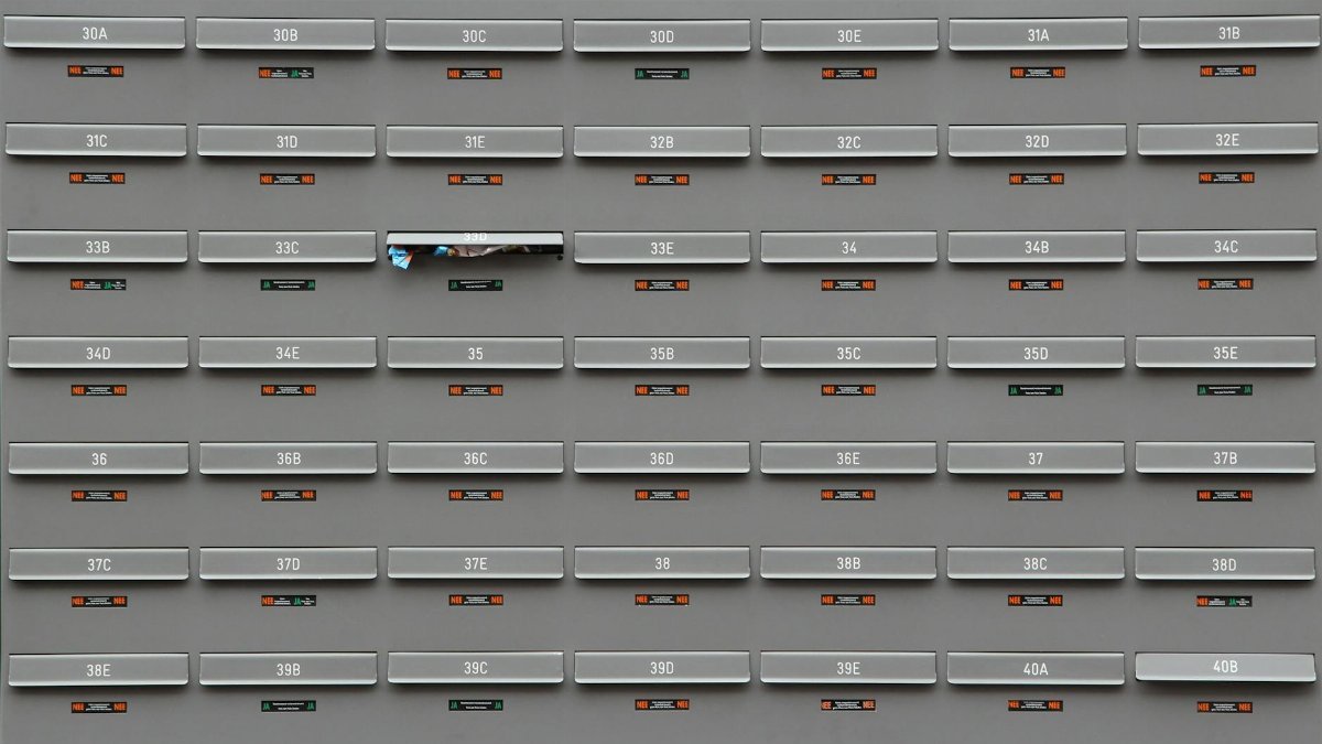 A grid of grey mailboxes with number labels showing an organized system.