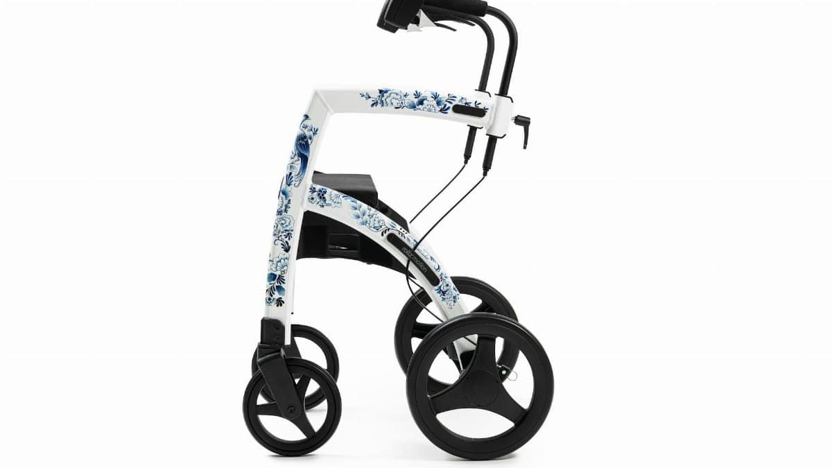 Side view of a floral-patterned rollator walker on a white background.