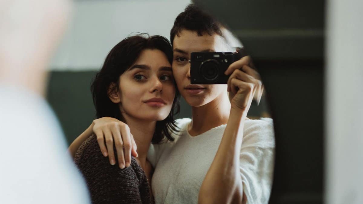 Intimate portrait of a couple capturing themselves in a mirror, perfect for lifestyle themes.