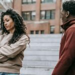 A couple in a heated argument outside, displaying frustration and dissatisfaction.