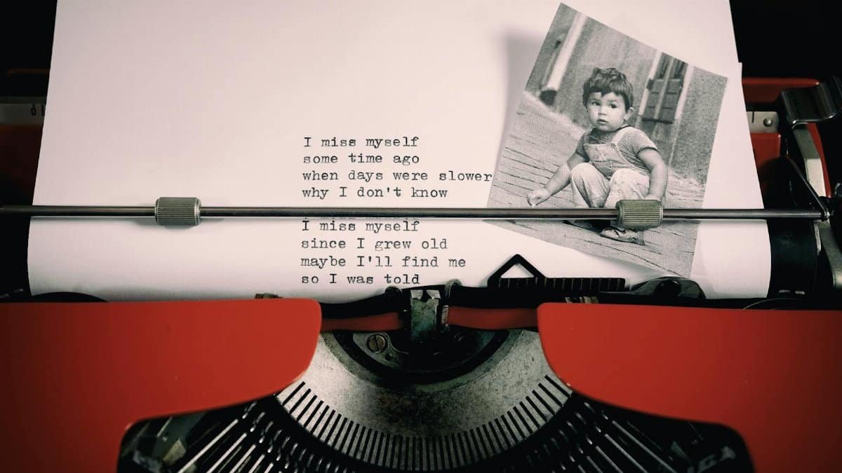 A nostalgic vintage typewriter with a poem and child's photo, evoking memories and the past.