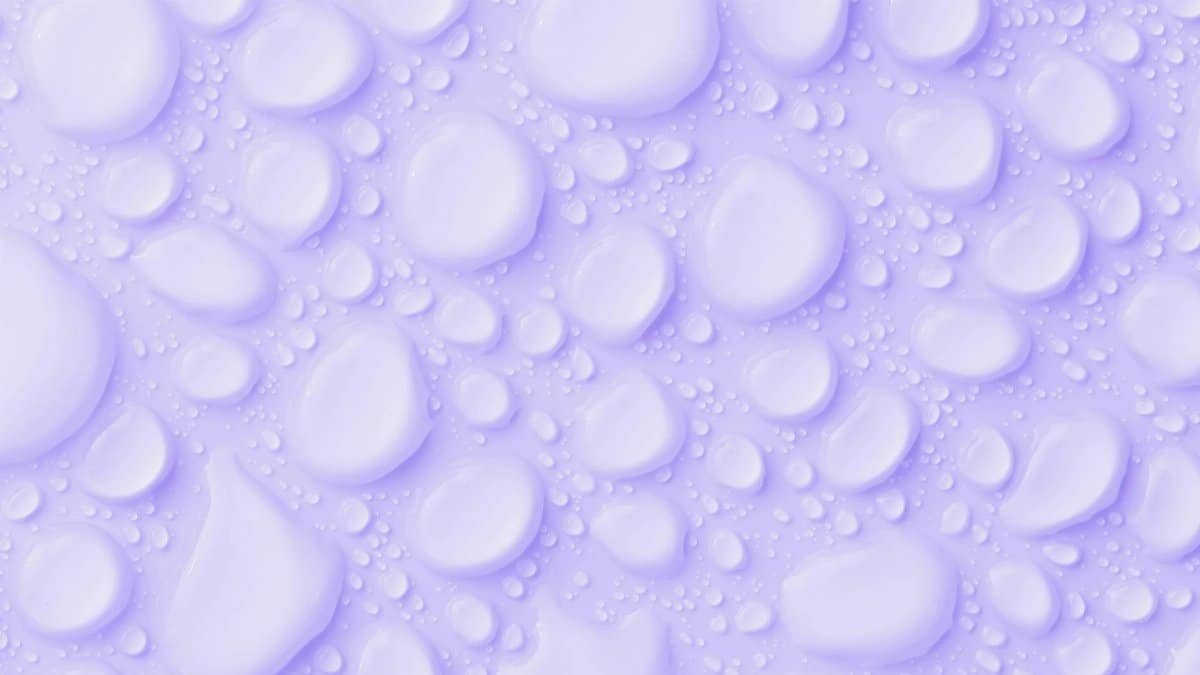 Close-up of water droplets on a lavender background, perfect for use as an abstract wallpaper.