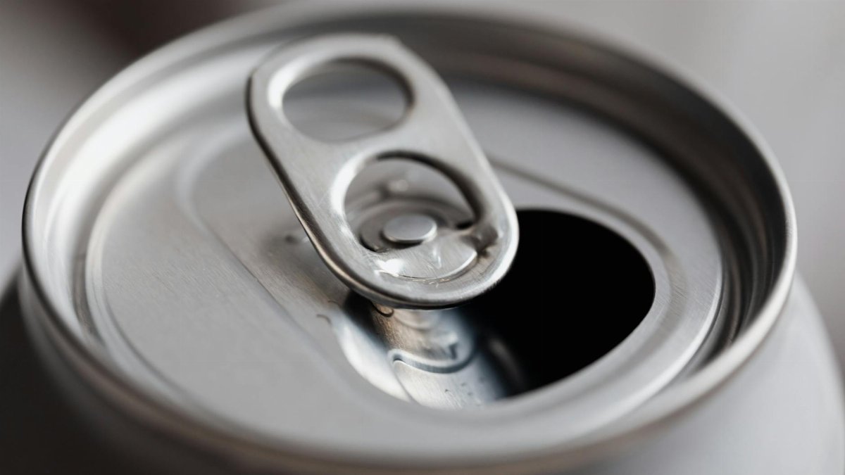 Close-up view of an open aluminum can, highlighting its metallic texture and design.