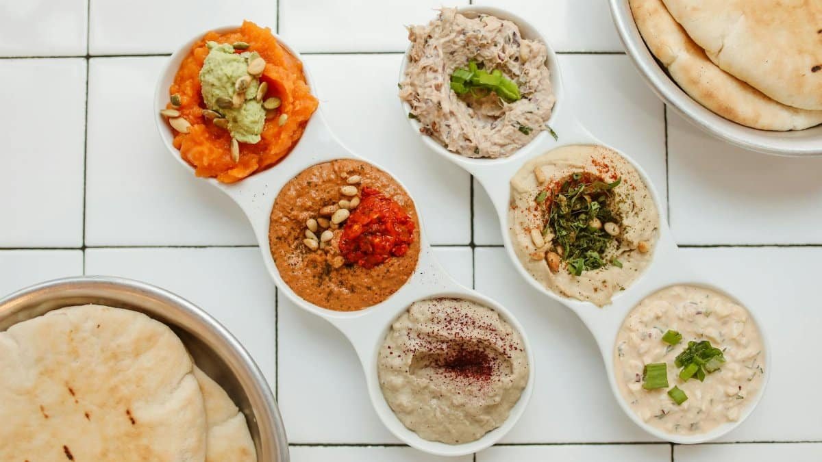Delicious Mediterranean dips served with warm pita bread. Perfect for a savory meal or snack.