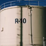 Large industrial storage tanks under blue skies, highlighting metal structures.