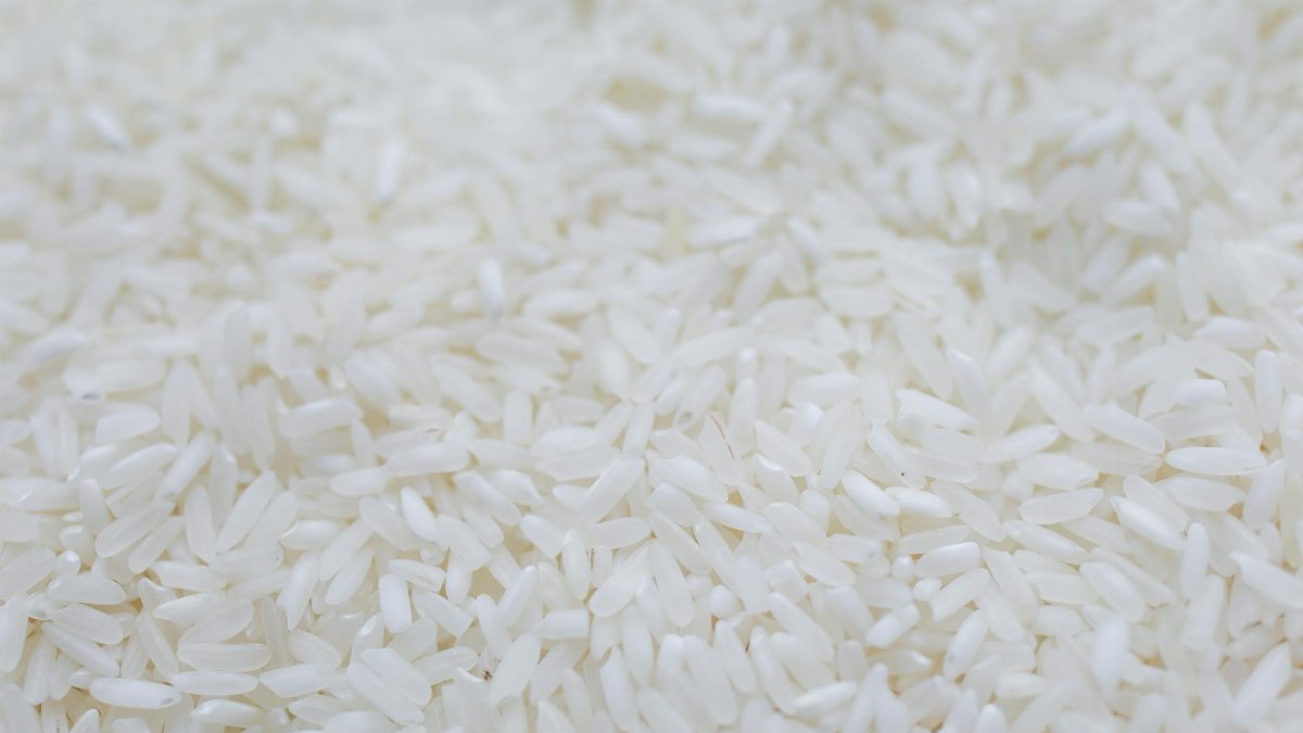 A detailed close-up shot of uncooked white rice grains, emphasizing texture and natural quality.