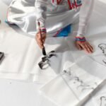 A person skillfully practicing calligraphy using traditional tools and techniques.