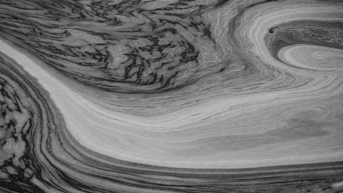 Intricate black and white abstract patterns resembling swirling water or liquid merging on a surface.