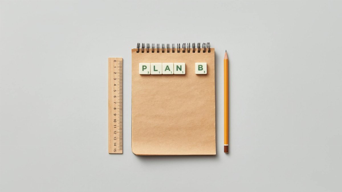 Minimalist flat lay of notepad, ruler, and pencil with Plan B tiles, perfect for creative work concepts.