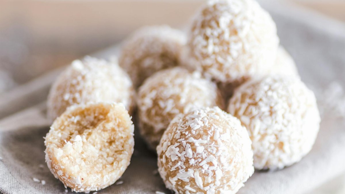 A close-up of coconut bliss balls on a linen cloth, showcasing their texture and sweet appeal.