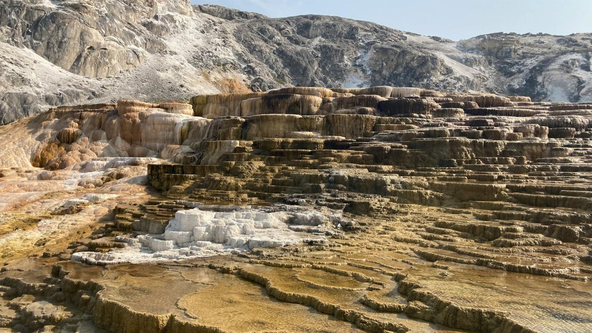 Discover the captivating landscapes of Mammoth Hot Springs, Yellowstone with its unique travertine terraces.