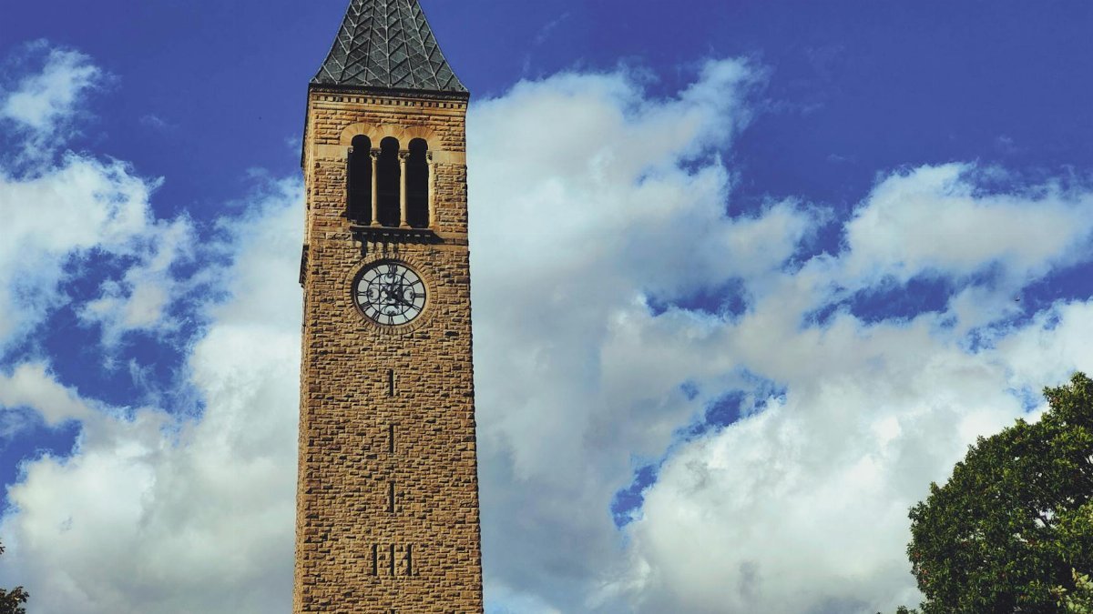 A captivating view of the historic clock tower at Cornell University with a dramatic sky backdrop.