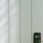 A sleek payment terminal with a card inserted against a light wooden background, showcasing modern commerce technology.