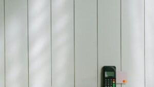 A sleek payment terminal with a card inserted against a light wooden background, showcasing modern commerce technology.