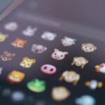Close-up view of various animal emojis displayed on a smartphone screen, representing digital communication.