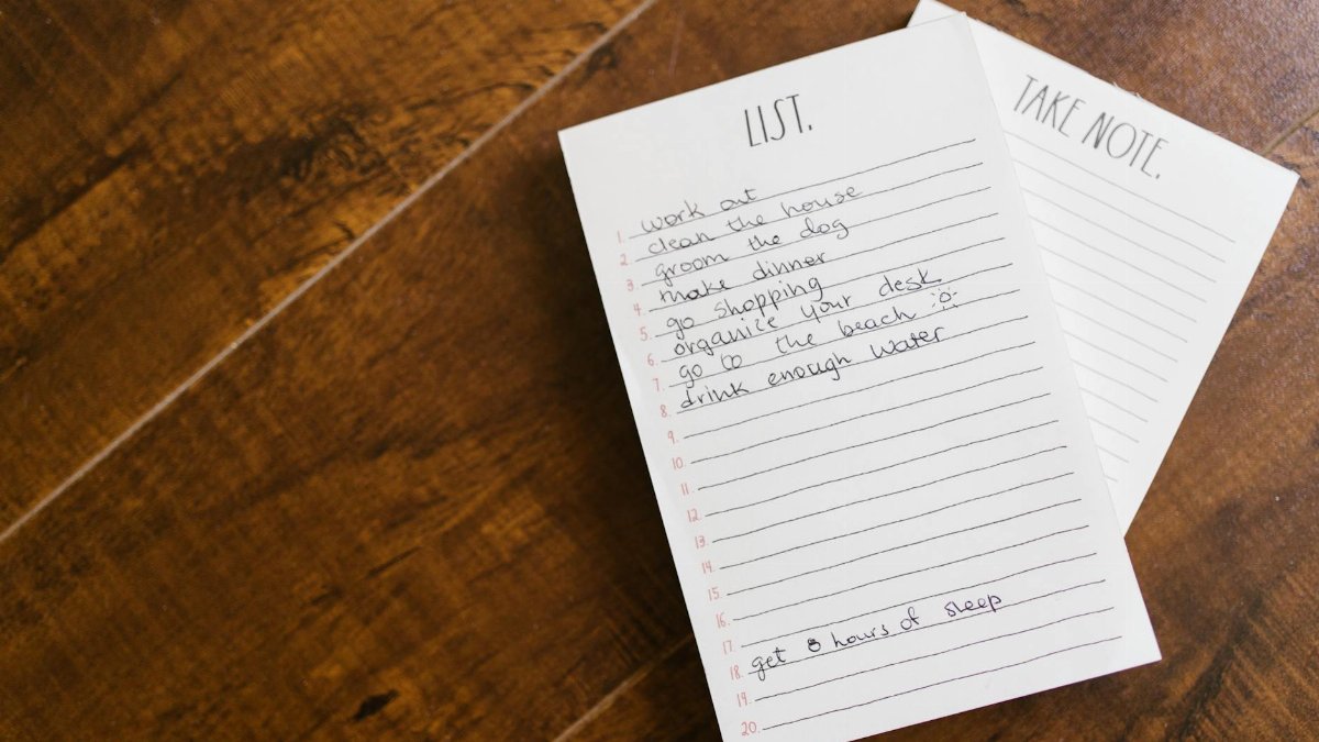 Close-up of a handwritten to-do list on a wooden surface, perfect for organization themes.