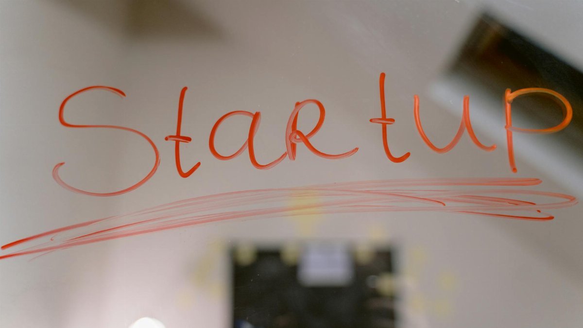 Conceptual image of startup text written on a mirror, symbolizing innovation and new beginnings.