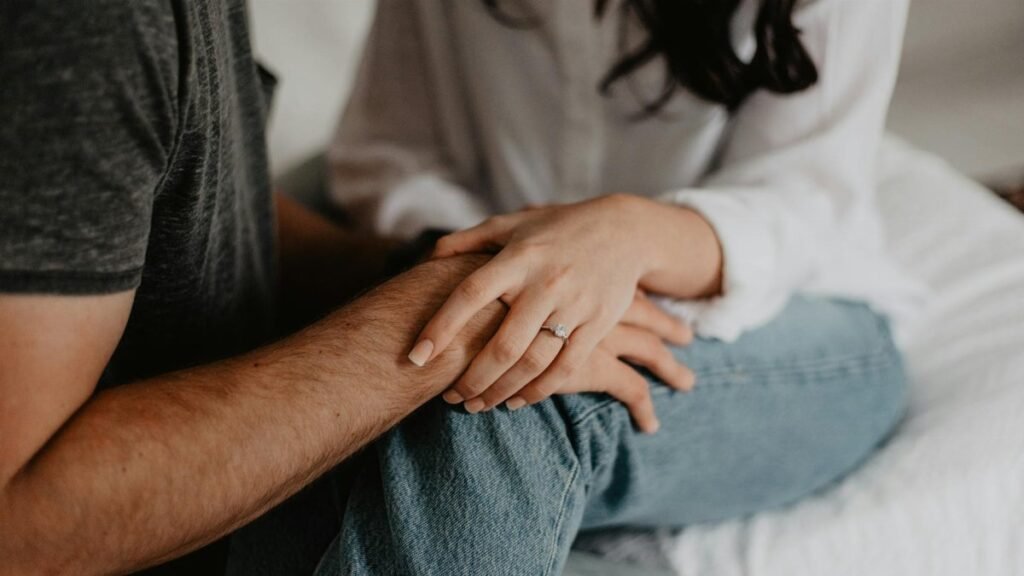 A tender moment of a couple holding hands, symbolizing love and connection.