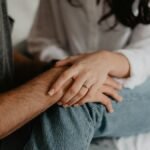 A tender moment of a couple holding hands, symbolizing love and connection.