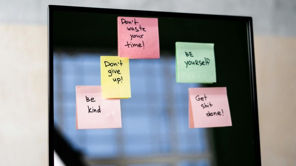 Colorful sticky notes on a mirror provide daily motivational messages and positivity reminders.