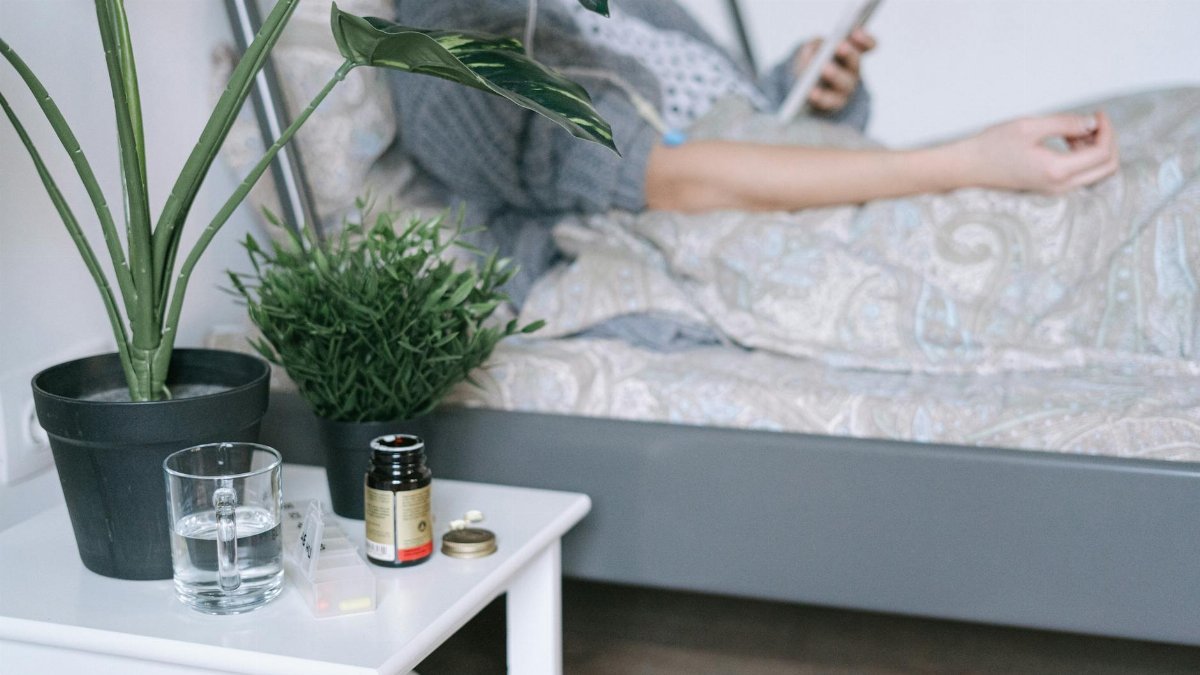 A patient resting in a hospital bed with care essentials nearby, illustrating a calm recovery environment.
